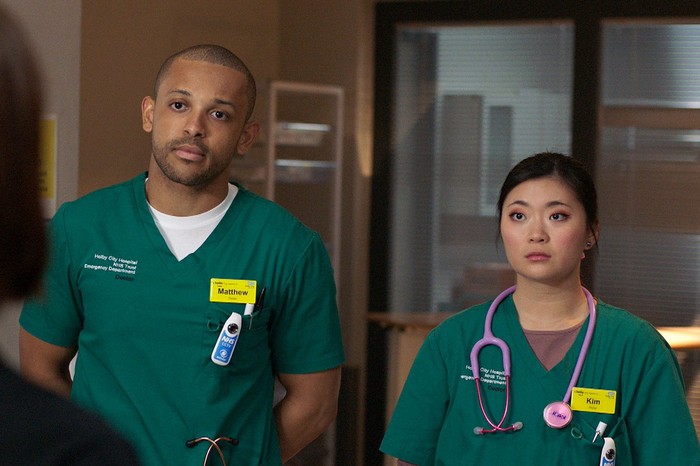 551605,TITLE:Casualty Matty and Kim wearing scrubs in a scene from Casualty