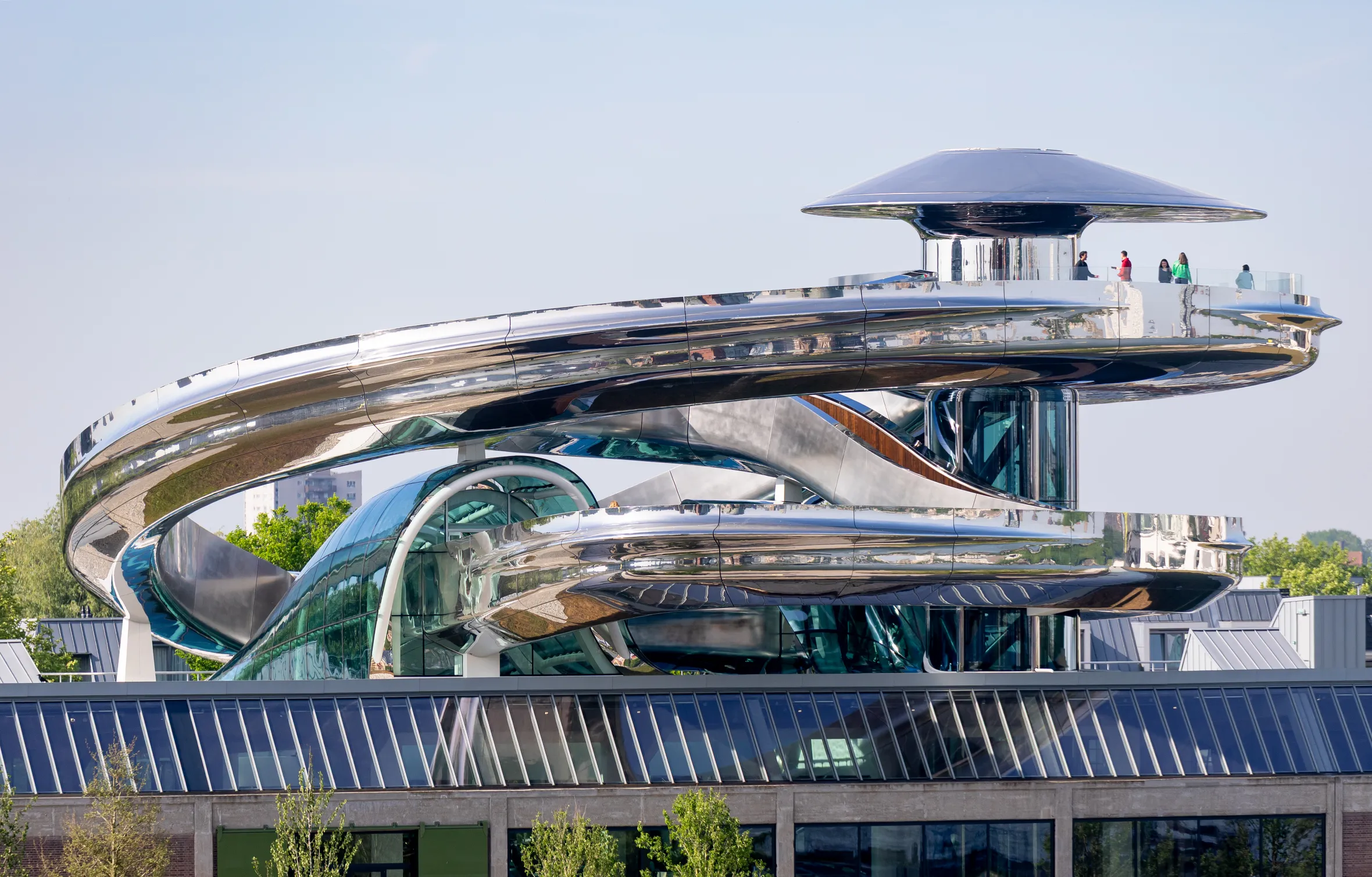 The Fenix Museum in Rotterdam, Netherlands, featuring a chrome-plated walking bridge and a viewing platform.