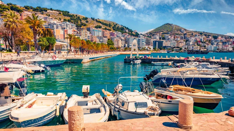 Wonderful spring cityscape of Saranda port. Beautiful Ioninian seascape. Colorful morning scene of Albania, Europe. Traveling concept background.