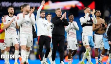 Salford City's players applaud their fans after a 2-0 defeat to Manchester City in the FA Cup