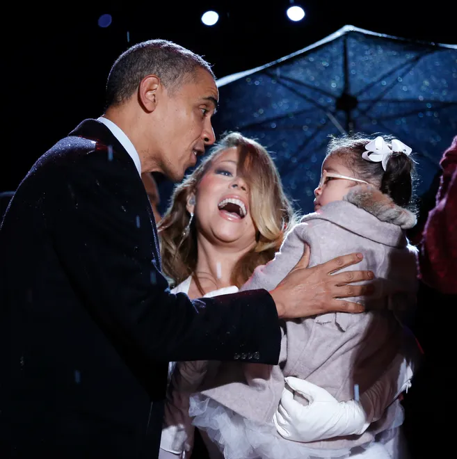 Singer Mariah Carey holds her daughter Monroe to meet U.S. President Barack Obama at the National Christmas Tree Lighting ceremony on the Ellipse in Washington December 6, 2013.