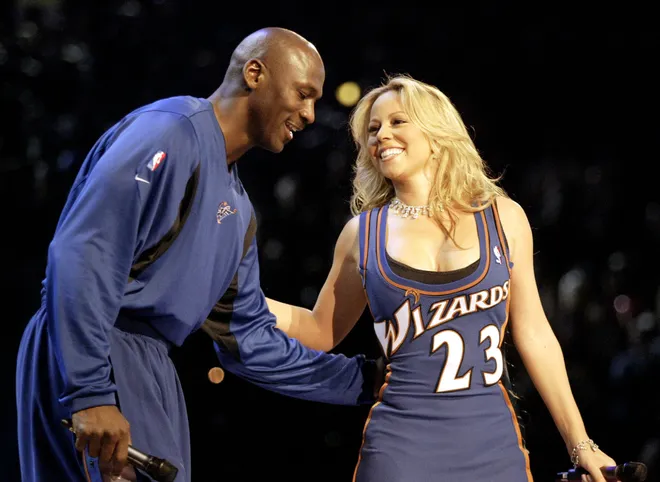 The Washington Wizards Michael Jordan, appearing in his 14th and final NBA All-Star game in February 2003, is greeted by singer Mariah Carey after she sang a tribute to Jordan during half-time festivities for the NBA legend.