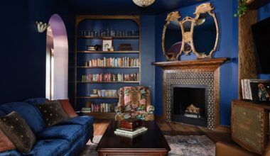 dark blue living room with wood fireplace and dark blue sofa