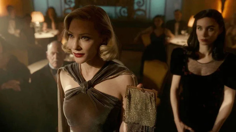 Cate Blanchett as Dr. Ritter and Rooney Mara as Molly standing together in Nightmare Alley