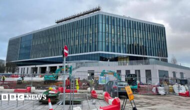 The University of Bristol, Temple Quarter Enterprise Campus in Bristol. It is a very large modern-looking building with glass frontage and a University of Bristol sign on the top. In the foreground is construction work on the building.