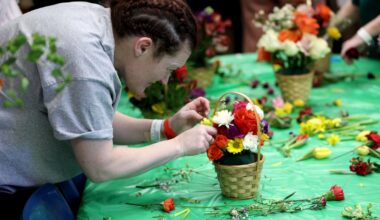 Jenni builds her bouquet during the Acton Garden Club Flower Day at Emerson Hospital.