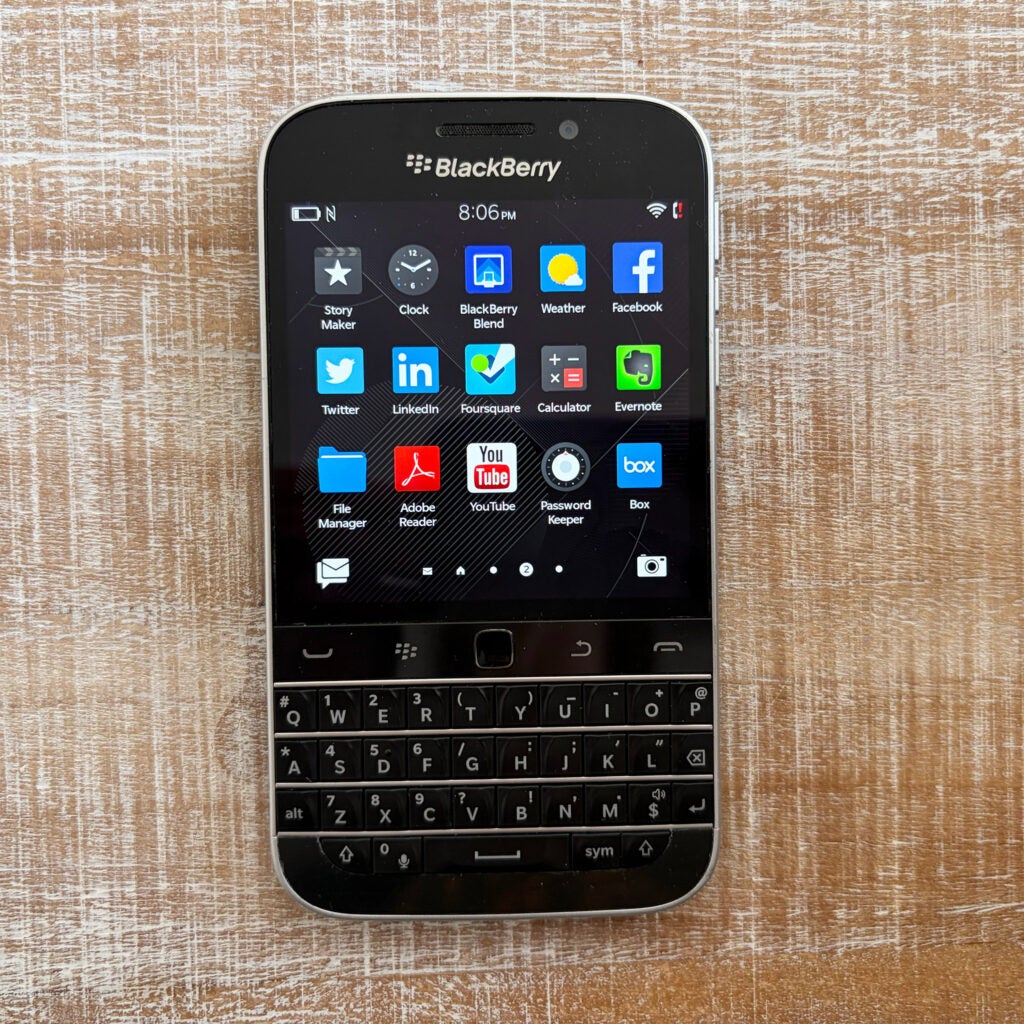 A BlackBerry phone powered on and displaying a home page with several apps.