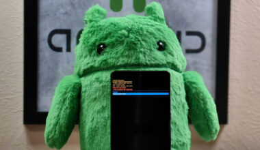 Photo of a Pixel 7 Pro in recovery mode in front of an Android plushie