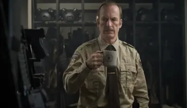 Bob Odenkirk is a sheriff, holding a cup of coffee in Normal.