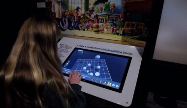 Visitors interact with displays at COSI’s “Science Behind Pixar” exhibit in Columbus, Ohio, which explores the science, technology, engineering and math behind animated films. (COSI)