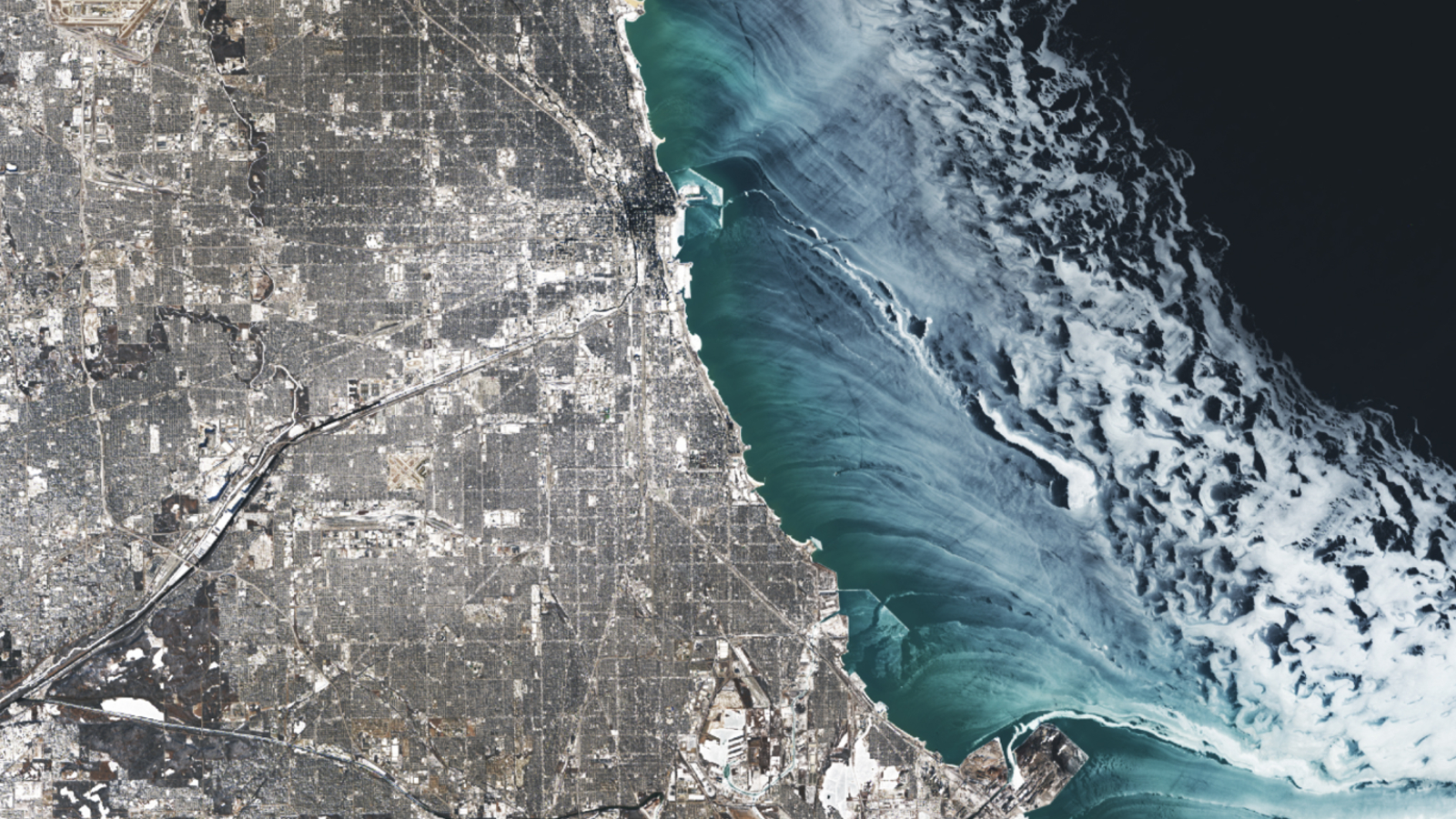 A satellite photo showing ethereal ice swirls along the shoreline of Chicago in Winter