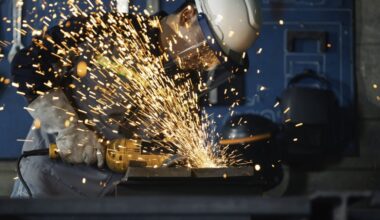 A man using a metal grinder causing sparks to fly.