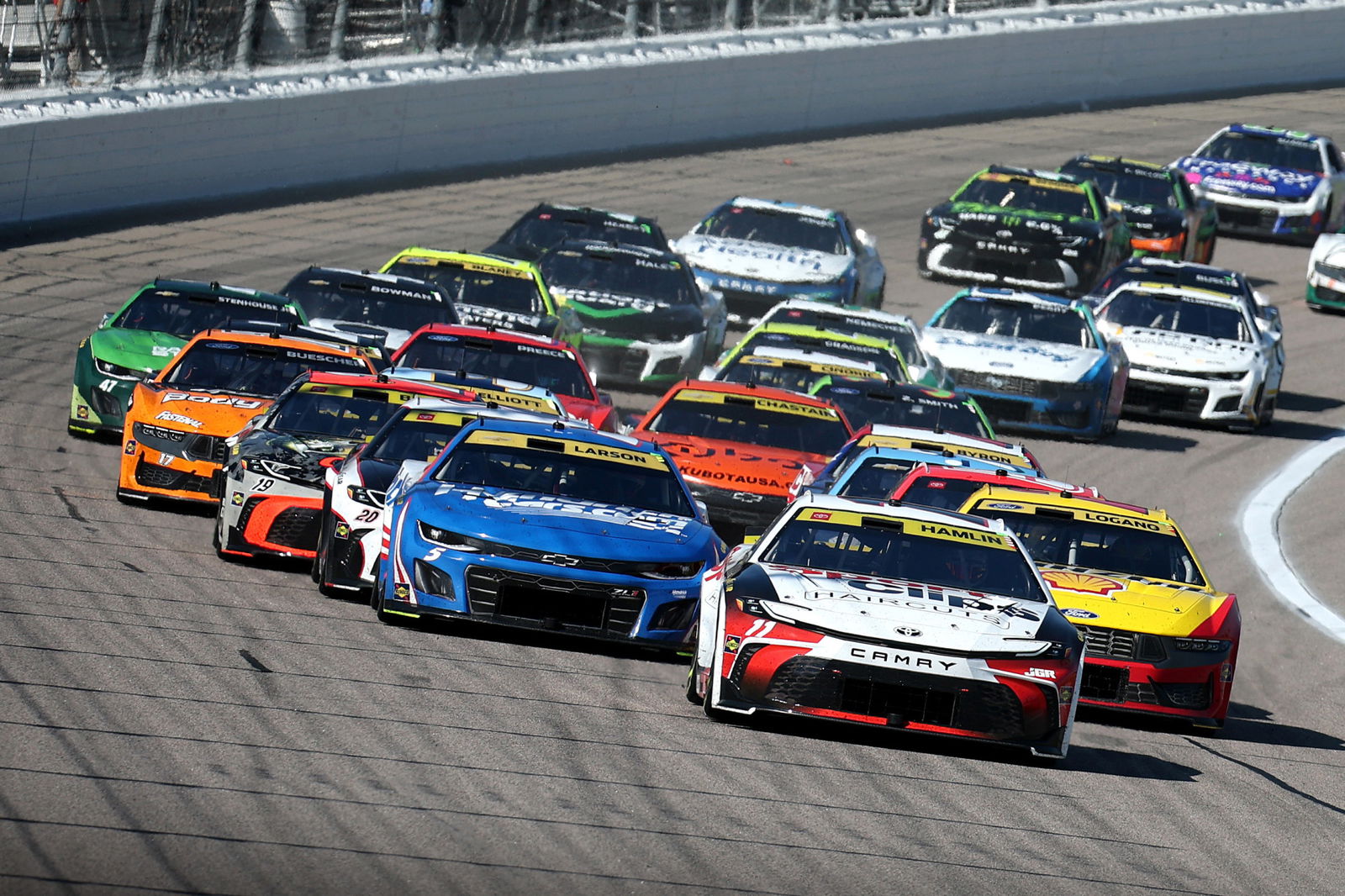Denny Hamlin leads the field during the NASCAR Cup Series Hollywood Casino 400 at Kansas Speedway.
