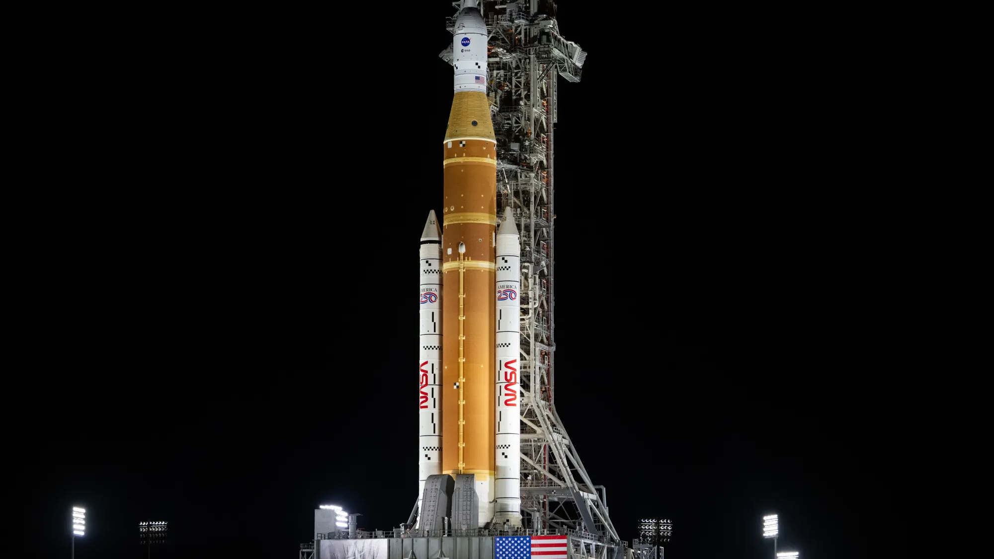 NASA's giant white and tan rocket on the way to the launch pad