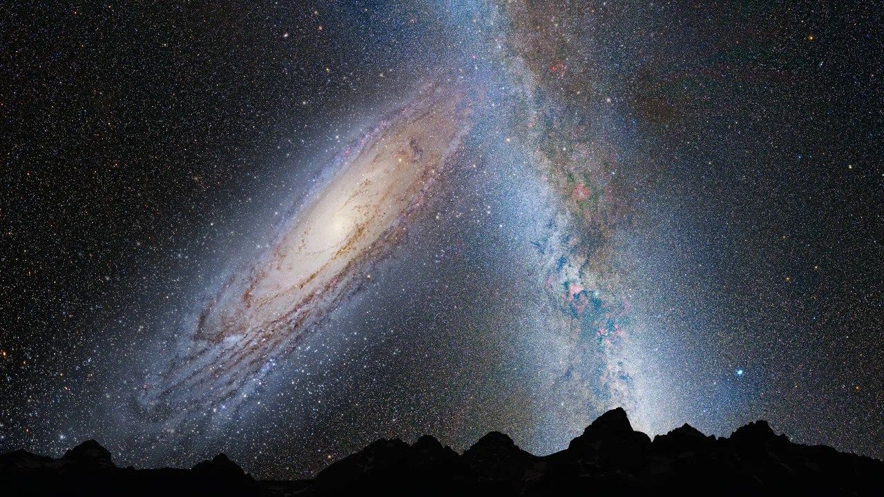 Illustration of the night sky over a dark, mountainous horizon. The sky shows a large spiral galaxy at an angle on the left and a milky white cloud of stars cross the sky vertically on the right.
