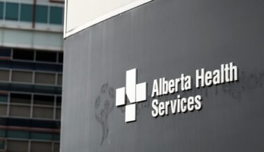 Photo of a sign on the exterior of a building that reads "Alberta Health Services."