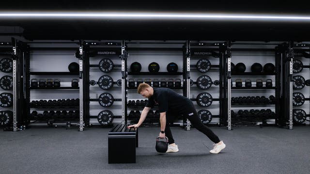Marchon coach Patrick James demonstrating how to perform a single-arm row with a kettlebell