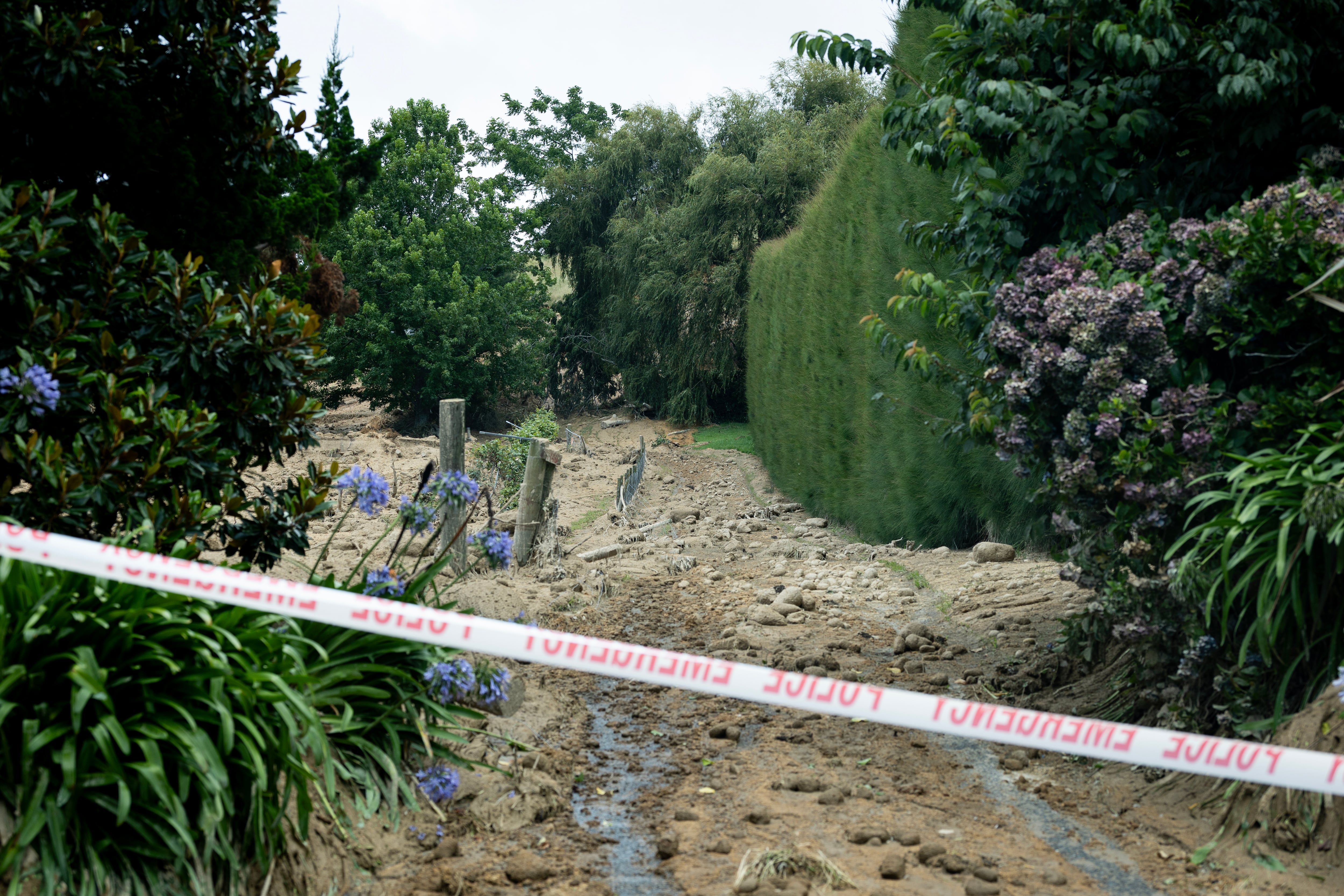 The thick mud blanketed the properties on Welcome Bay Rd, Pāpāmoa, Tauranga, after a fatal landslide on January 22, 2026. NZ Herald photo by Dean Purcell