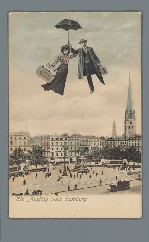 A woman and man float high above a city square using an umbrella, each carrying a suitcase. Below, people walk near buildings and a church with a tall spire. Text reads "Ein Ausflug nach Hamburg.