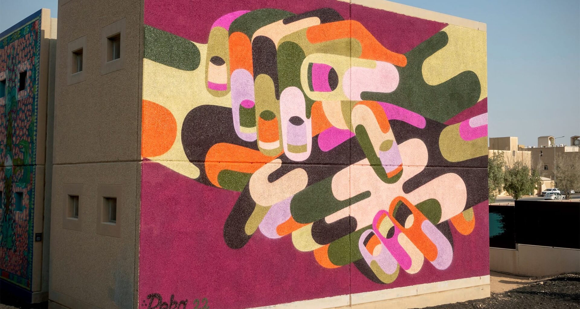 a vibrant abstracted mural of hands by James Reka