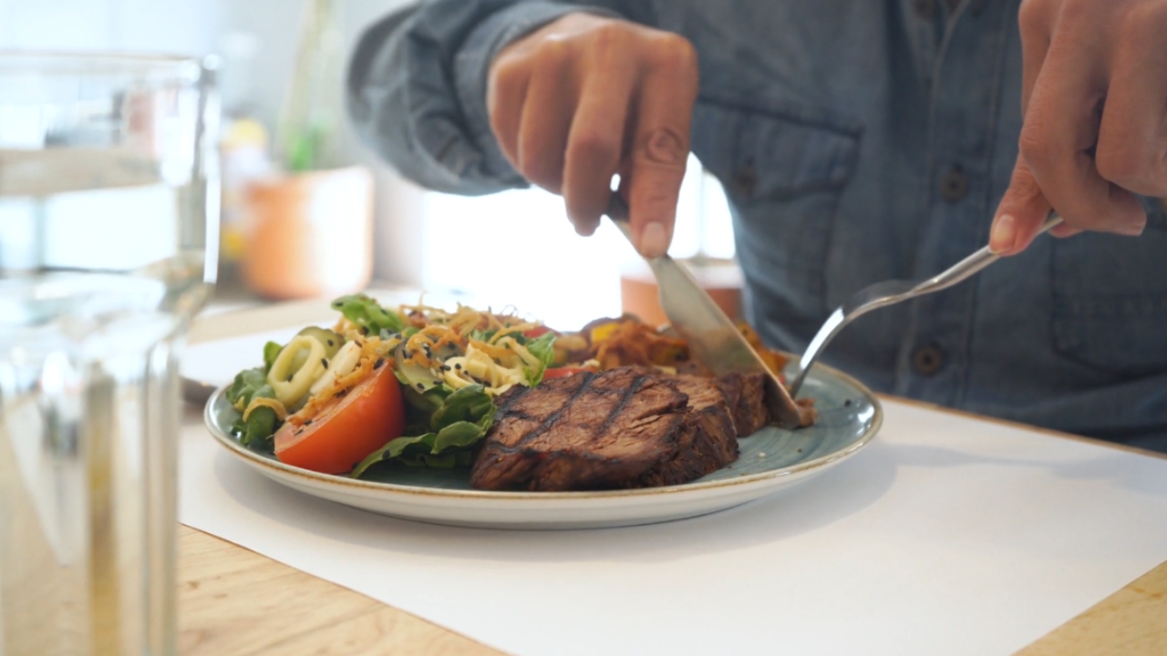 Plate with steak and salad as a meal example linked to meat eaters and longevity research