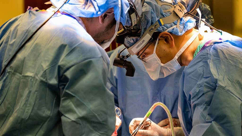 Minimally invasive robotic surgery performed by surgeons in an operating room.