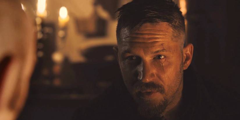 Taboo Tom Hardy in front of candles