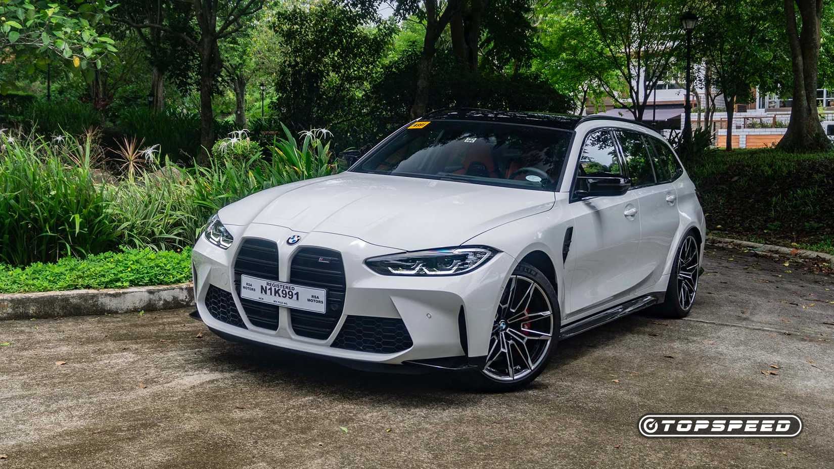 Front 3/4 view of a 2024 BMW M3 Competition Touring