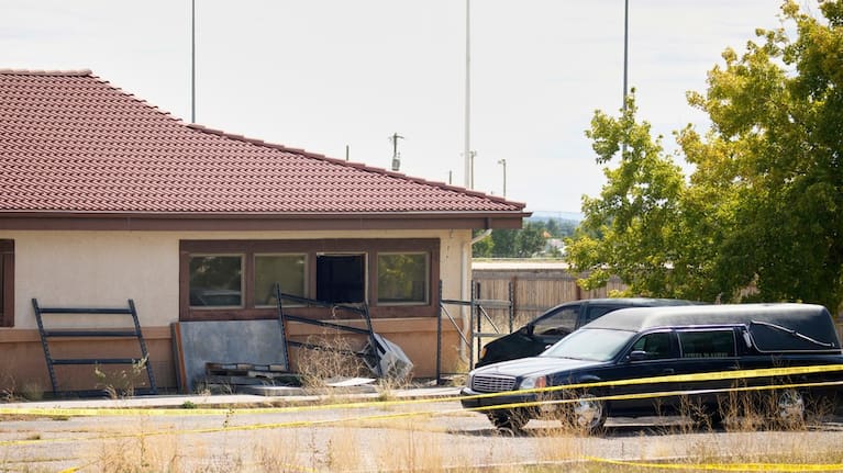 A hearse and van sit outside the Return to Nature Funeral Home in Penrose, Colorado.