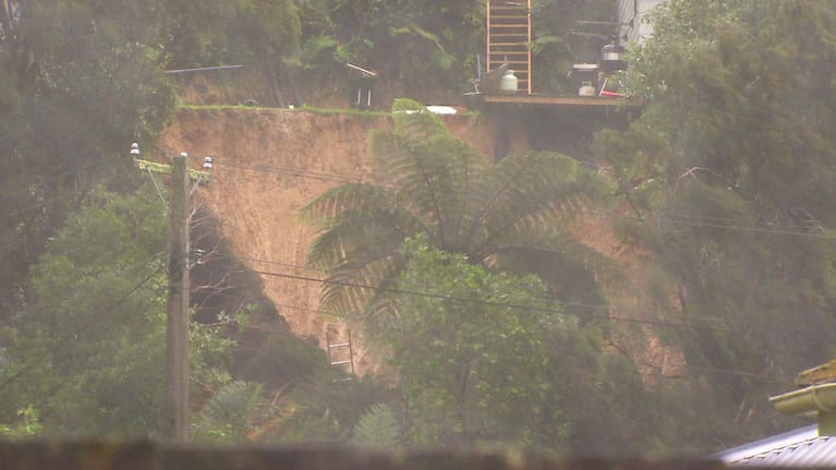 A large slip left Aaron Pahl's family home hanging exposed when a nearly 10 by 30 square metre expanse of yard disappeared down the bank.