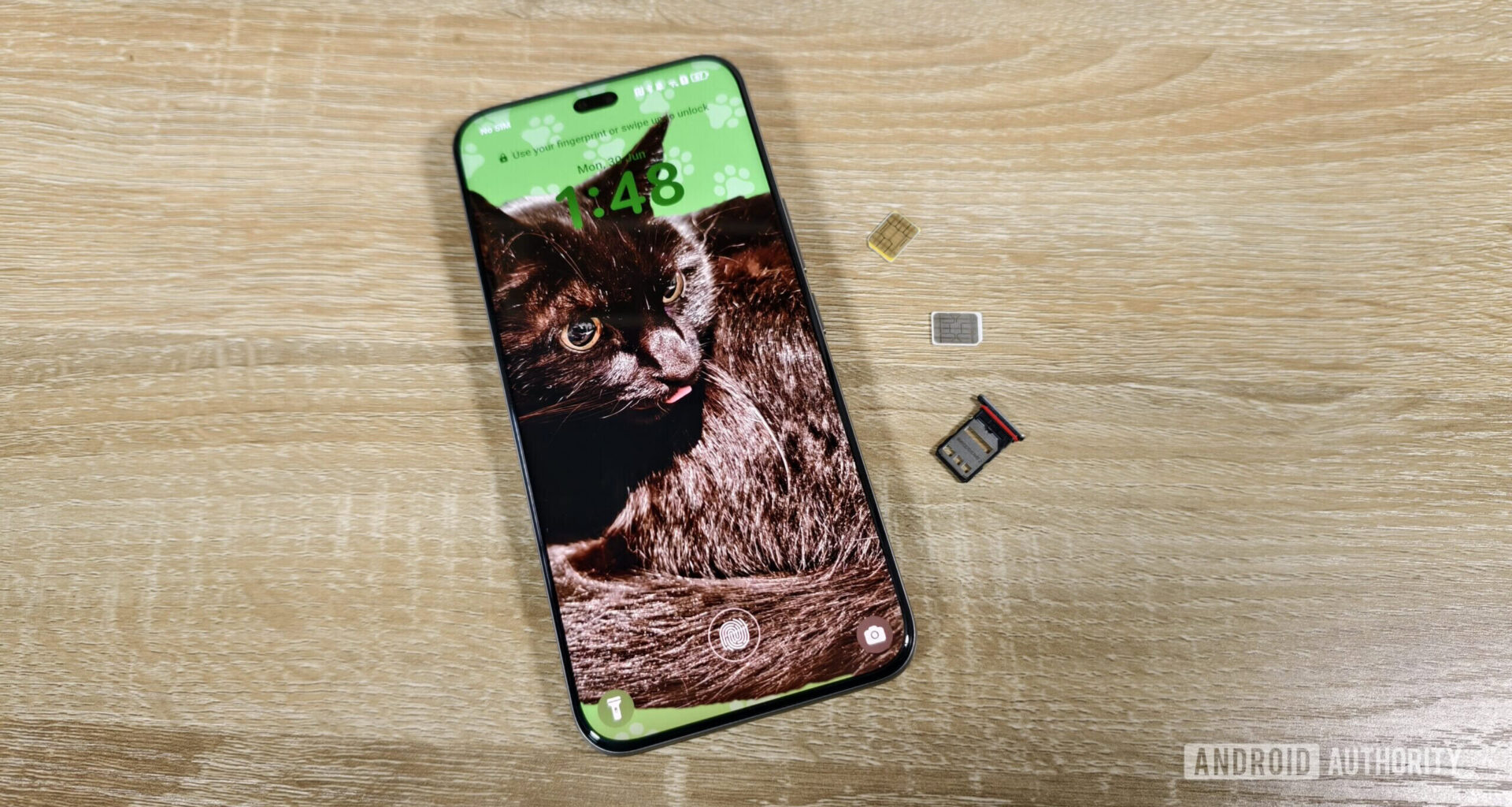 a smartphone with two sim cards and a sim tray on a table