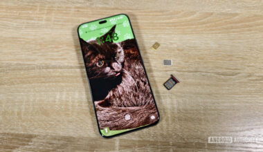 a smartphone with two sim cards and a sim tray on a table