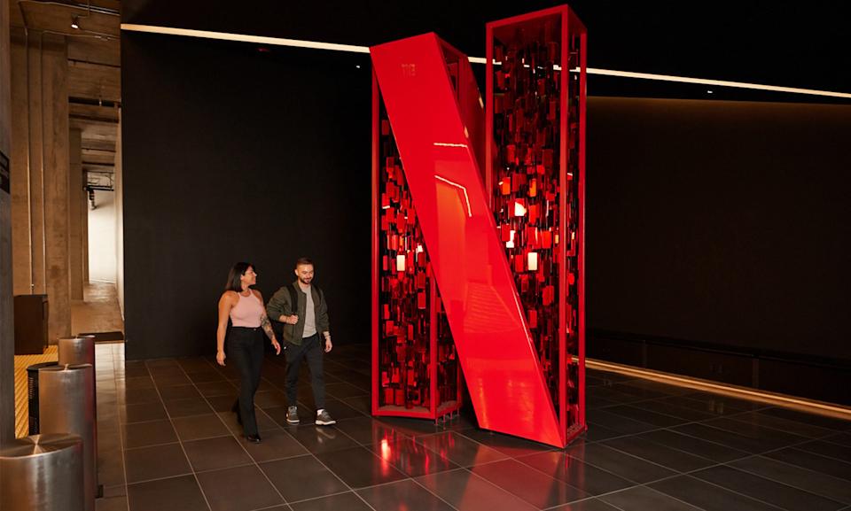 Large Netflix logo sculpture in office building.