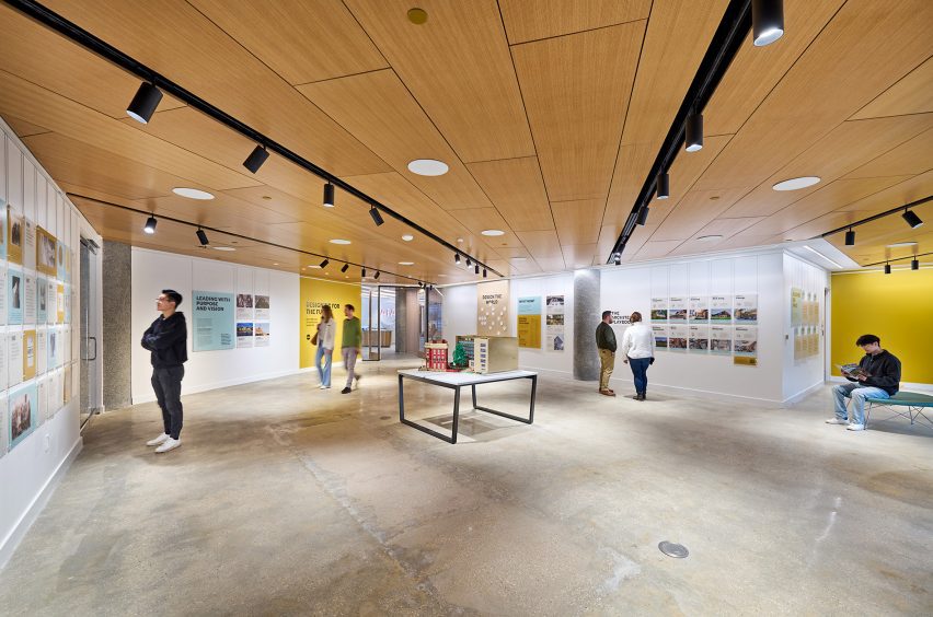 Large exhibition space featuring concrete floor and wood-lined ceiling