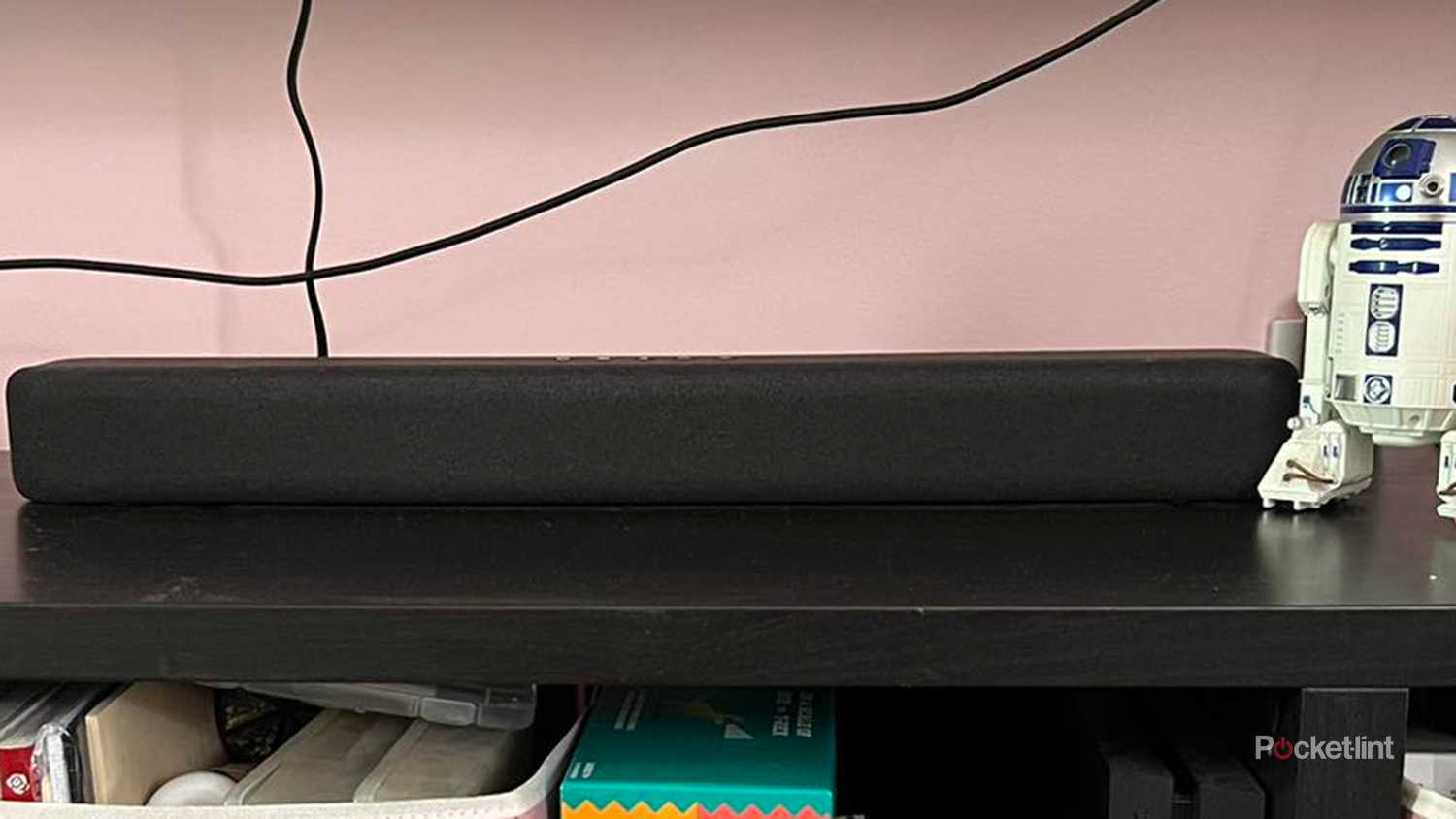 Amazon Fire TV soundbar on TV stand.