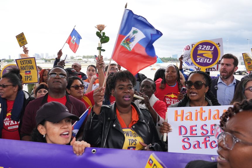 People chant during a rally in Florida in support of the extension of Temporary Protected Status, known as TPS, for Haitian immigrants before it expires on February 3.