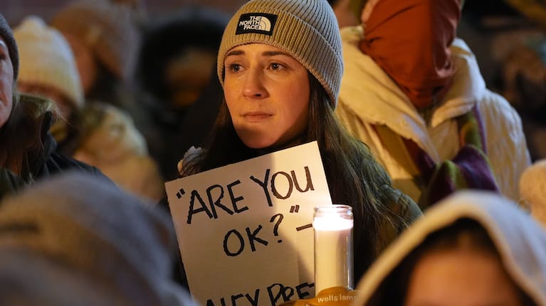 Attendees gather during a vigil where Alex Pretti was shot and killed.