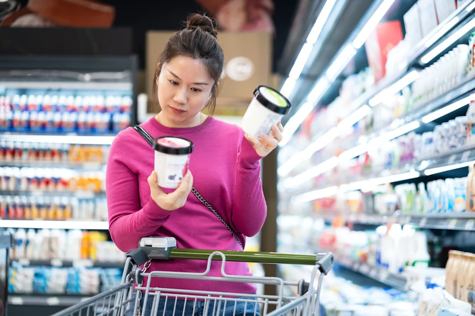 female shopping in the cold produce section of a supermarket
