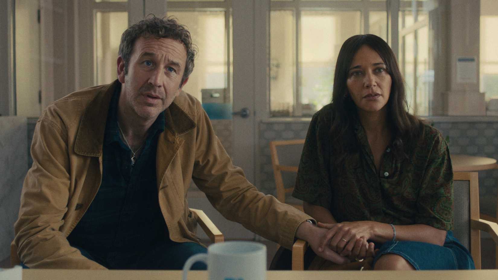 Chris O'Dowd and Rashida Jones holding hands in Black Mirror's Common People