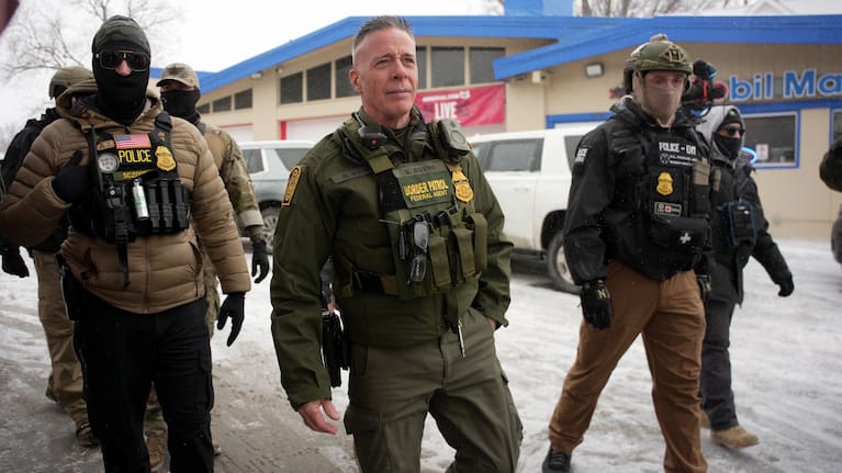 Border Patrol Cmdr. Gregory Bovino walks with Federal agents.