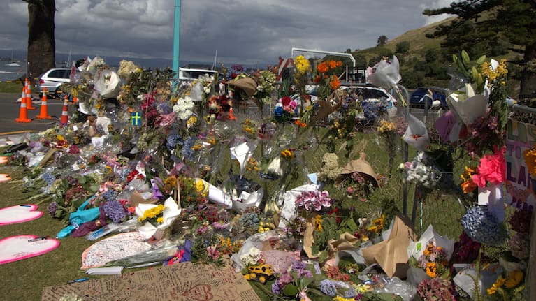 Bouquets and tributes at the Mount Maunganui landslide cordon.