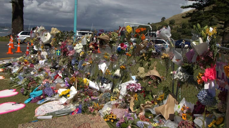 Bouquets and tributes at the Mount Maunganui landslide cordon.
