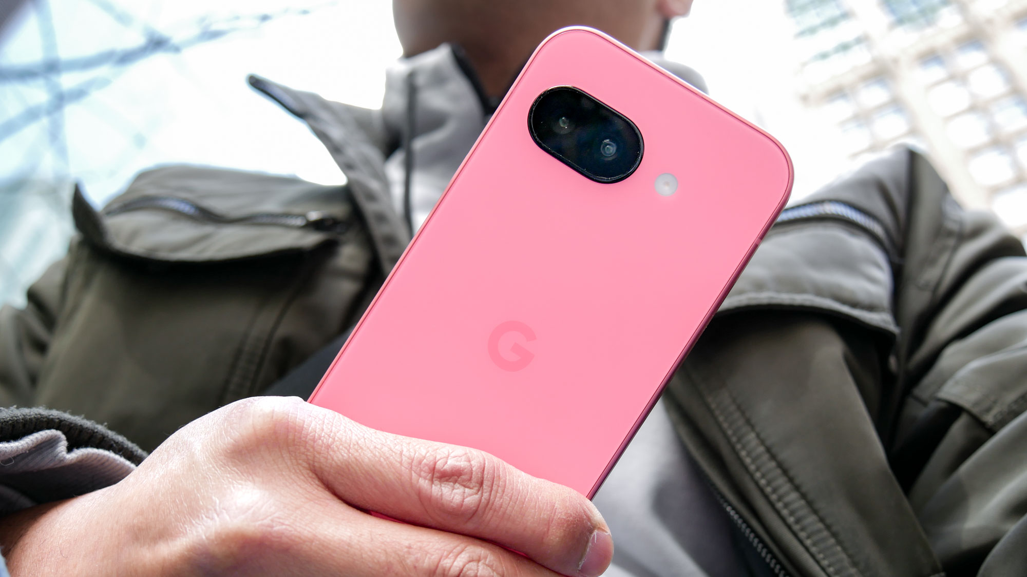 Google Pixel 9a held in the hand.