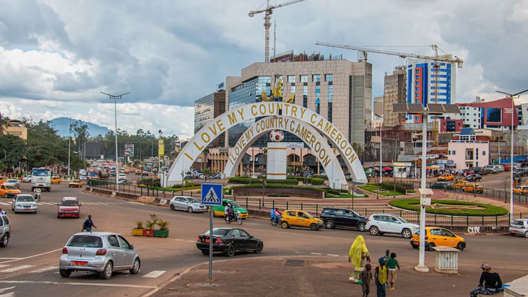 Cars drive through an intersection near a monument in Yaoundé, Cameroon, Sept. 12, 2025. 
