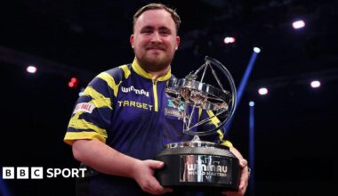 Luke Littler holding the World Masters trophy
