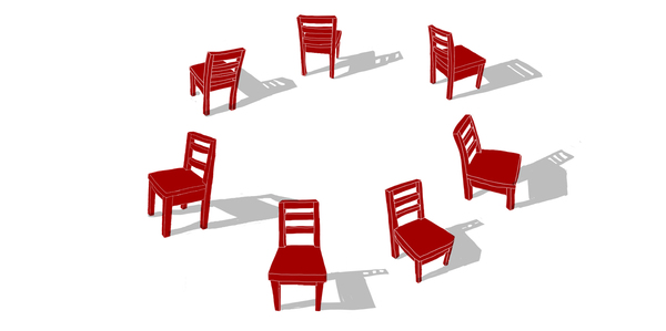 A circle of red wooden chairs arranged in a circular pattern on a white background, casting shadows.
