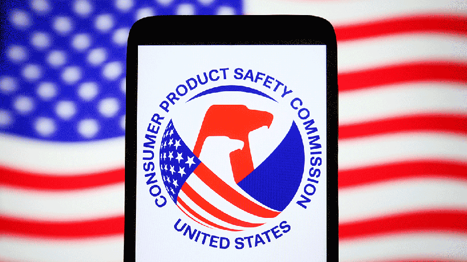 A Consumer Product Safety Commission (CPSC) logo is seen on a smartphone and the U.S. flag on a pc screen.