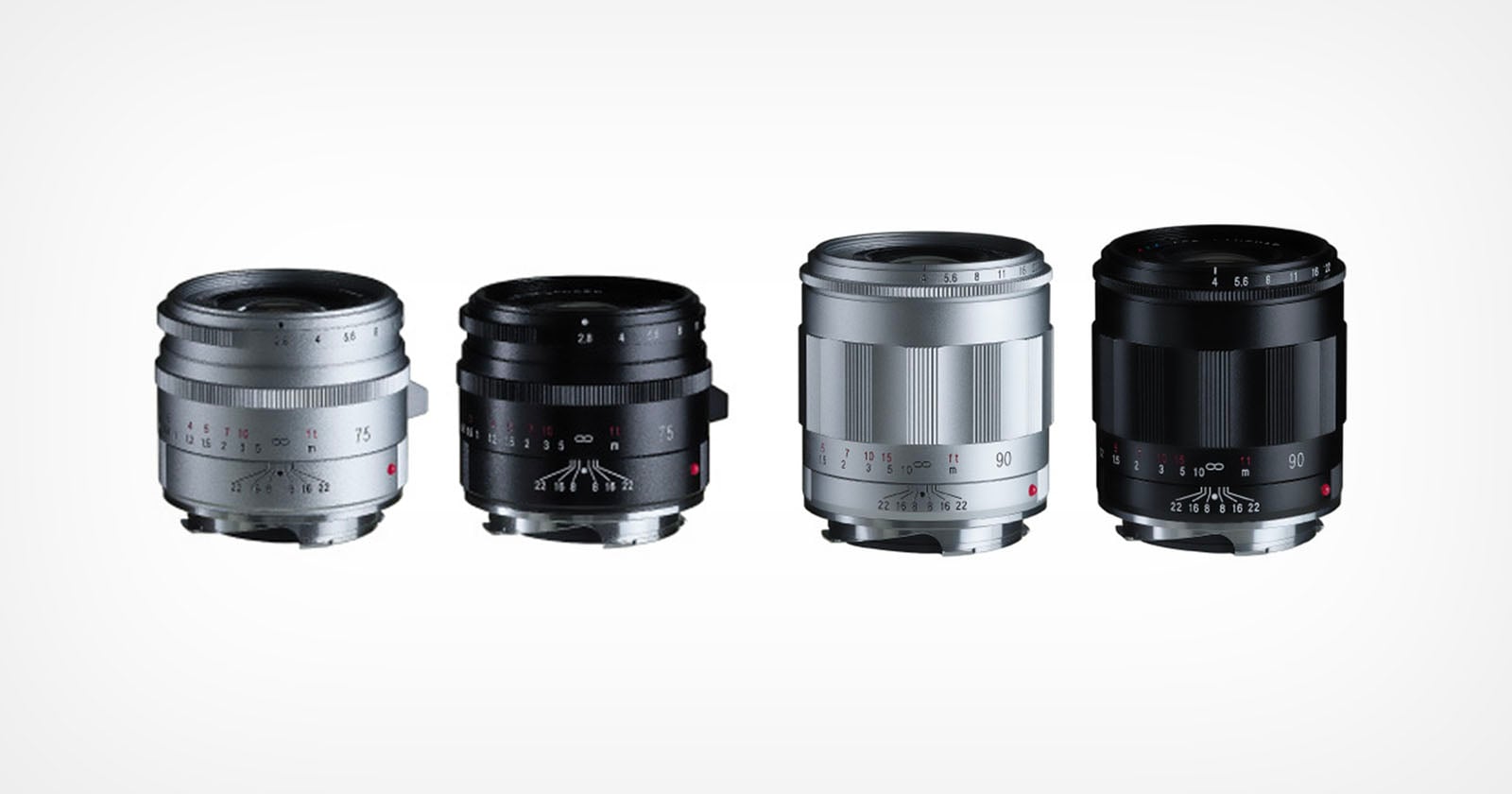 Four camera lenses are arranged in a row on a white background, with two lenses in silver and two in black. The lenses are compact and have visible focus and aperture markings.