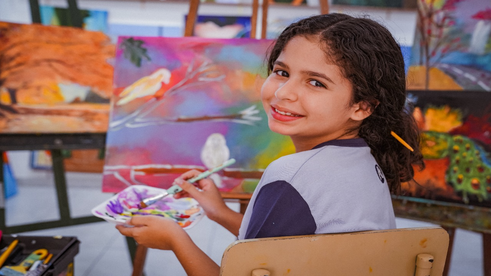 Sophia Helena painting a picture in her studio before an exhibition at the Louvre.