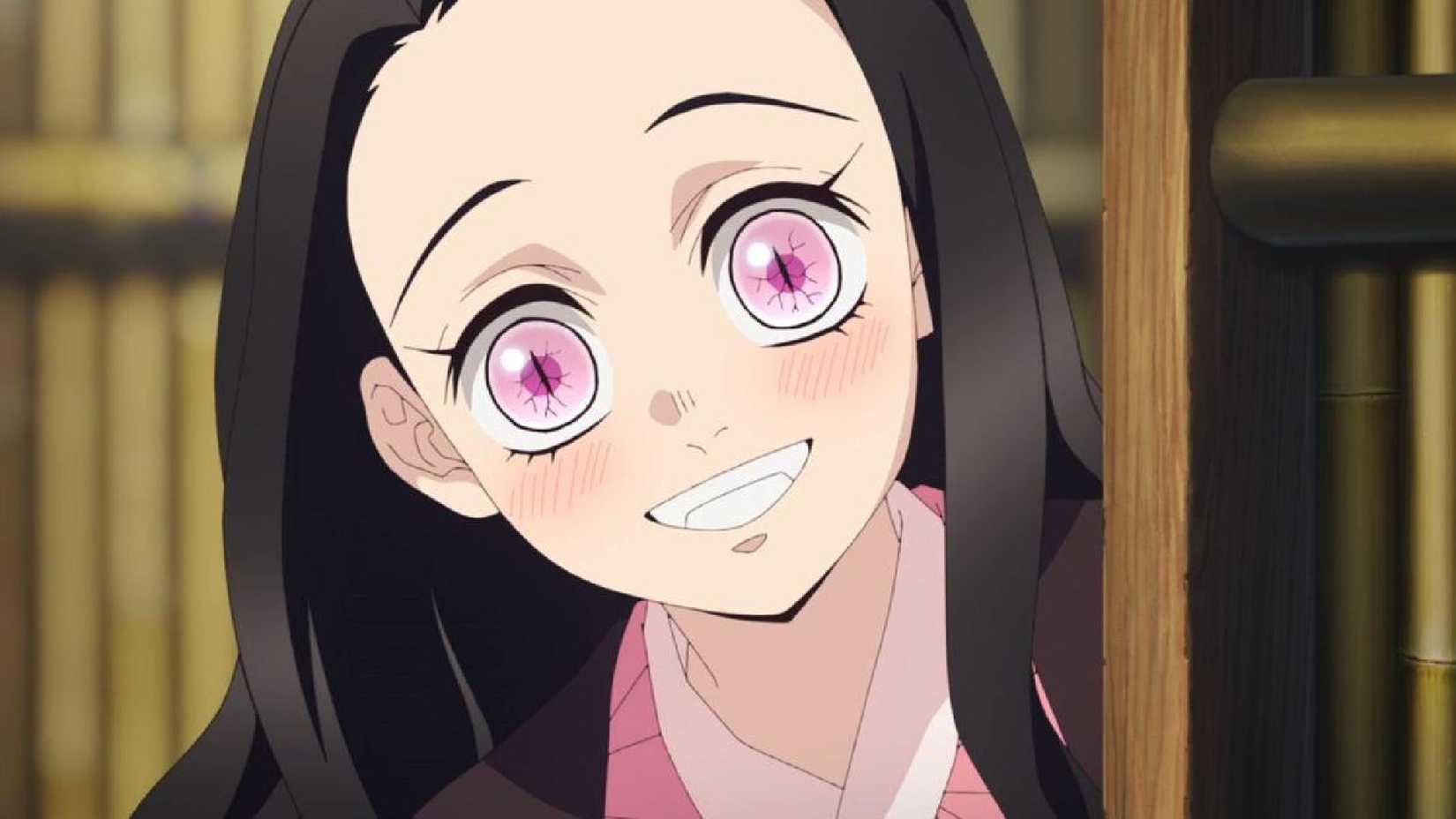 Demon Slayer's Nezuko smiles broadly while peeking out from behind something.